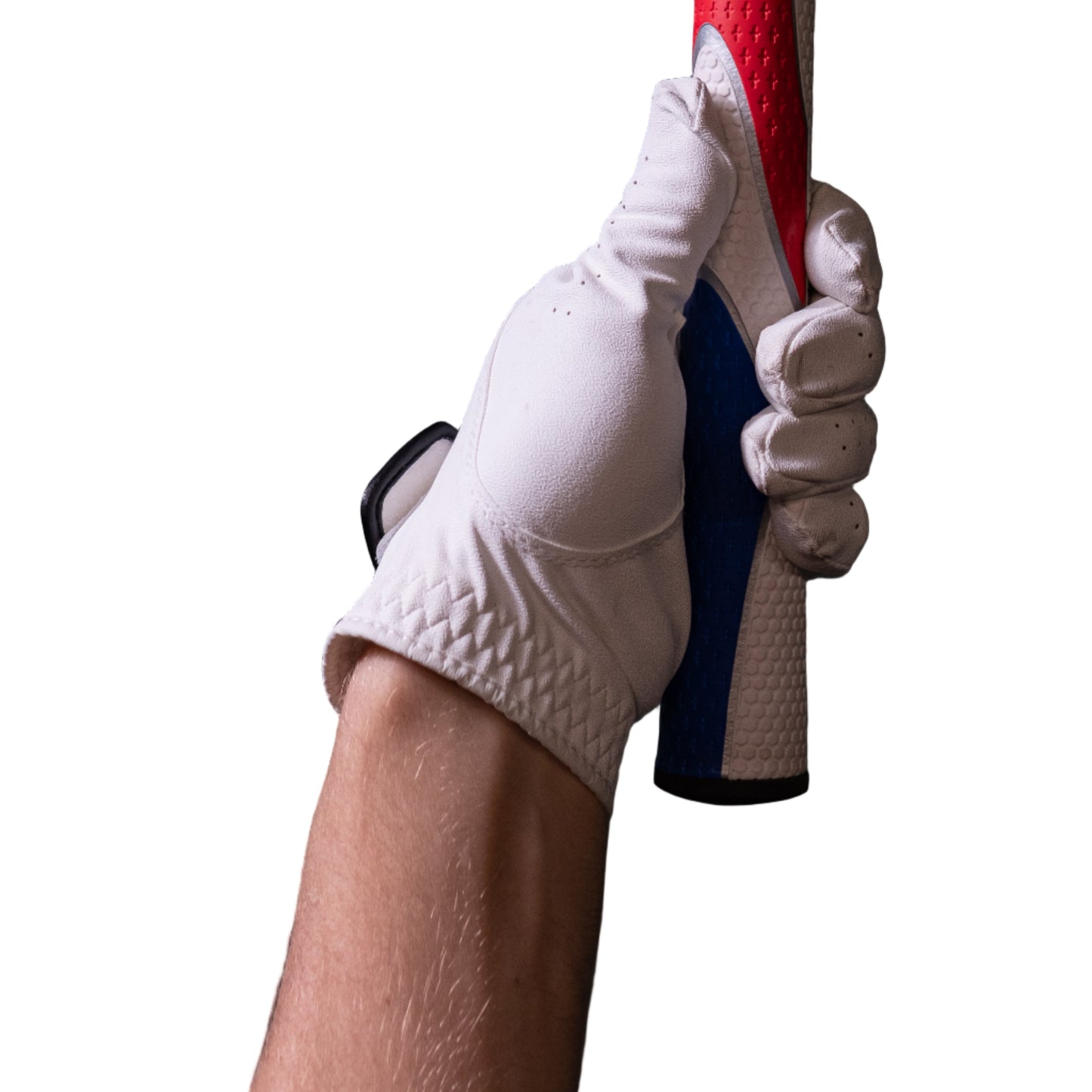 Hand wearing a white glove holding a red and blue broom against a dark tiled wall.