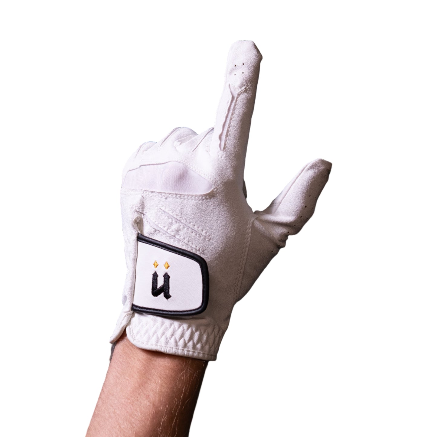 White golf glove with a logo on a hand against a dark tiled wall